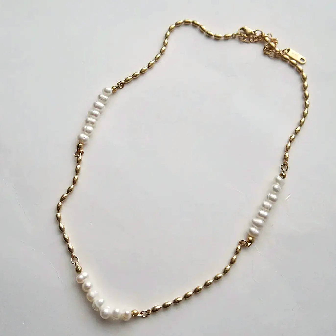 Pearl and gold-plated link choker necklace shown at full length