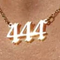 Angel number pendant hanging from a fine gold-plated chain