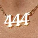 Angel number pendant hanging from a fine gold-plated chain