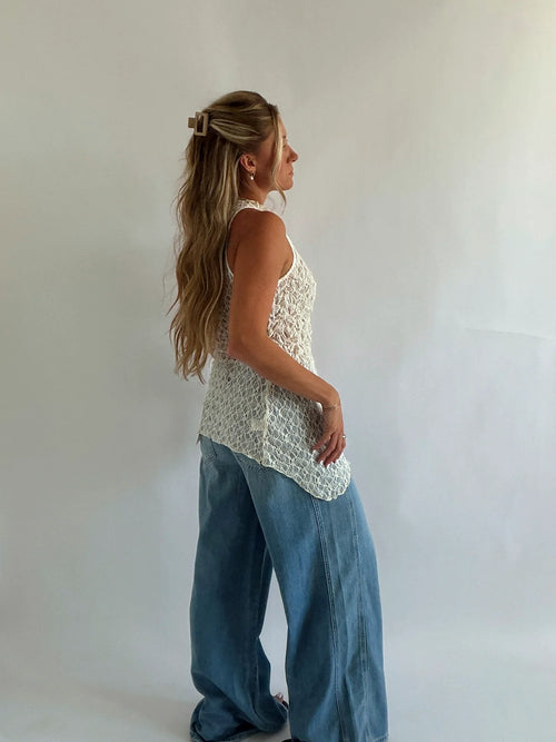 Side view showing the asymmetrical line of the lace top