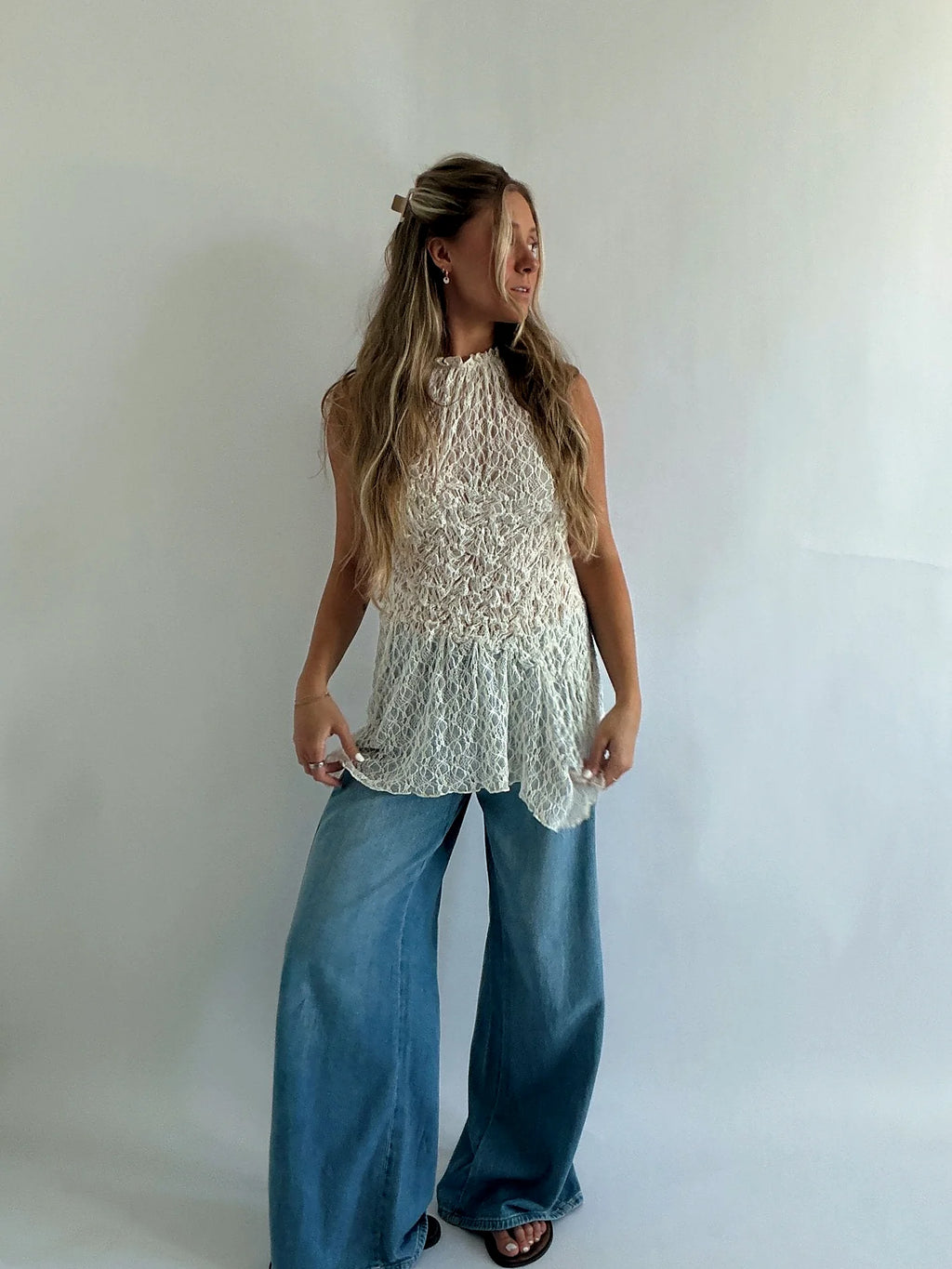 Lace top with a high neckline and gathering drawn in at the waist