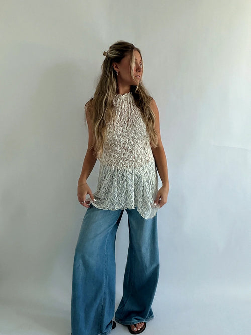 Lace top with a high neckline and gathering drawn in at the waist