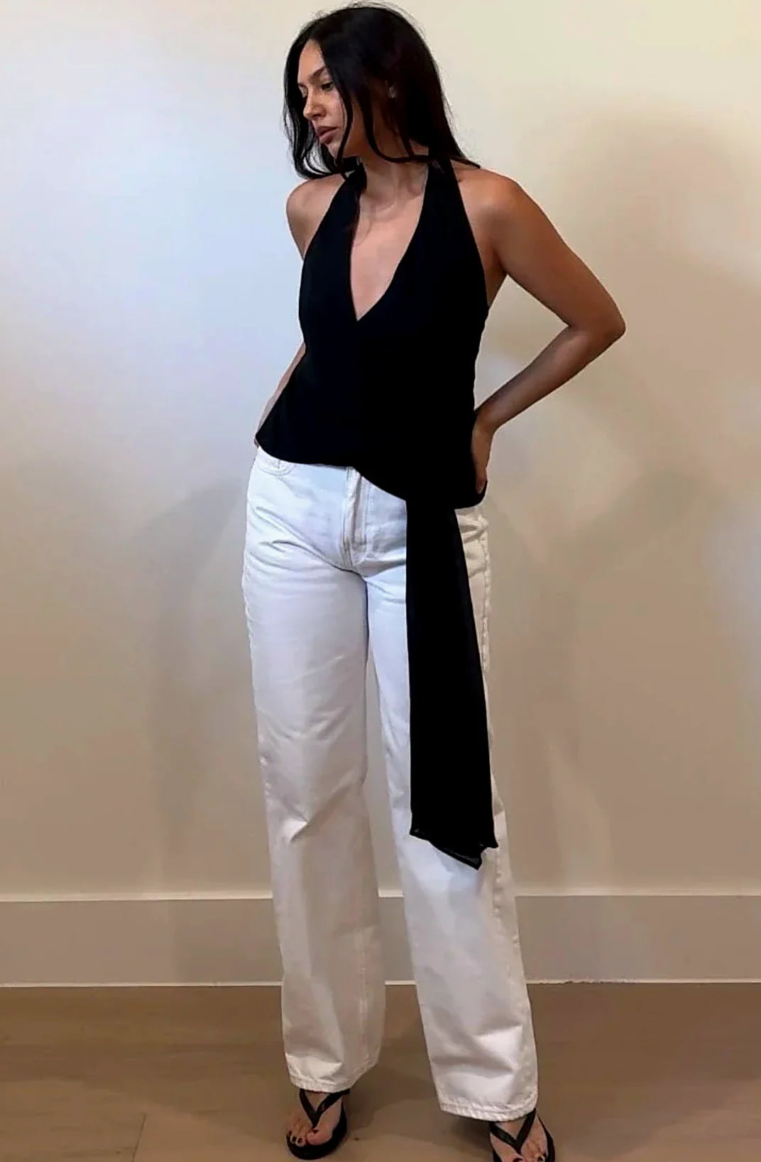 Black halter top with a deep V neckline and side tie