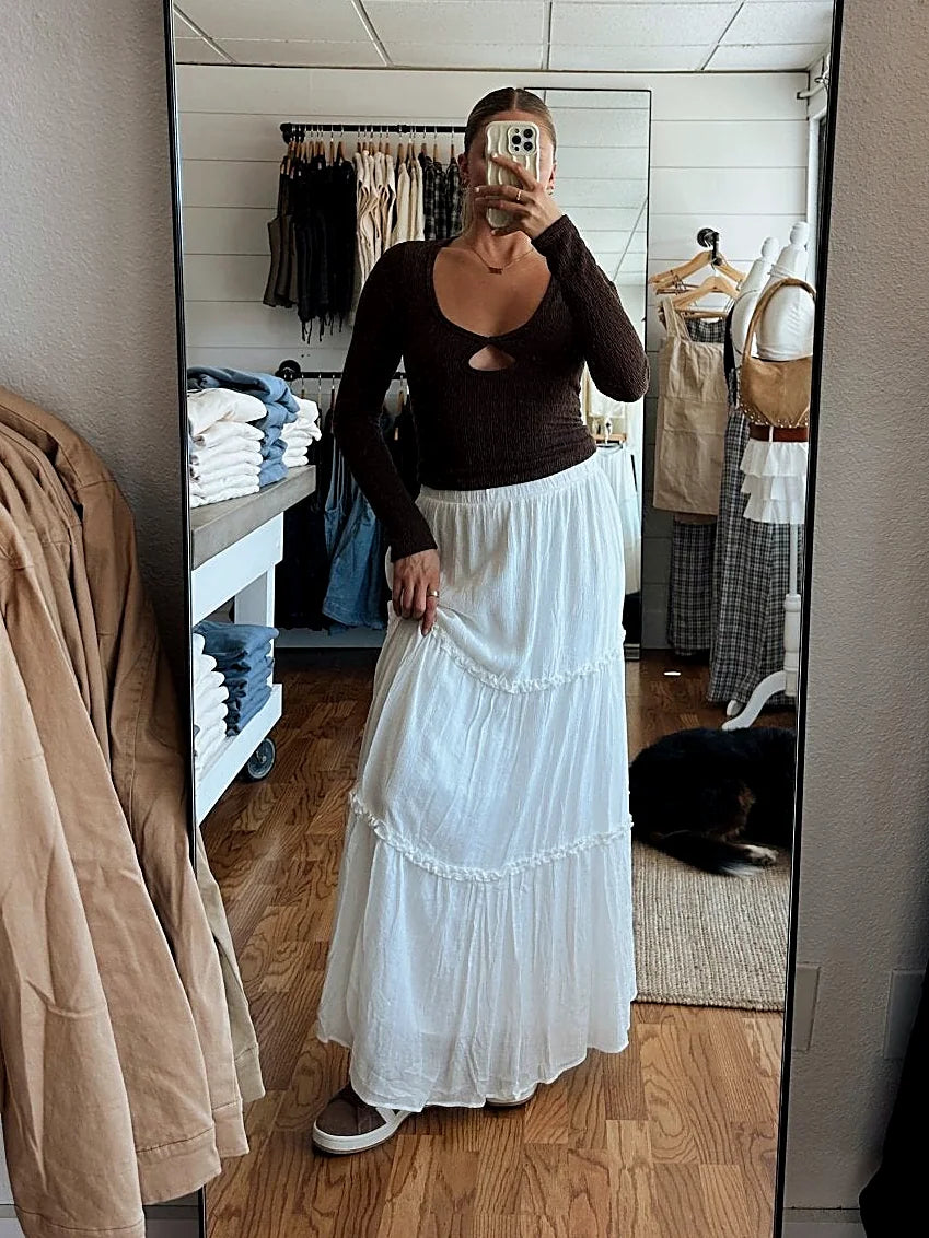 The sleek fit of the brown knit top shown from the side