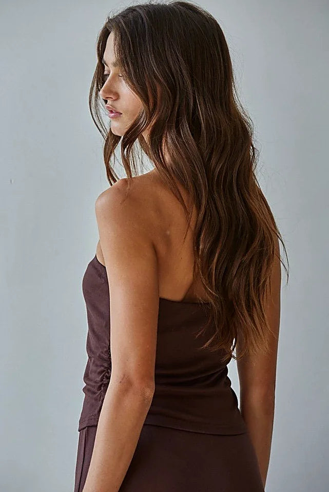 The straight neckline of the brown tube top