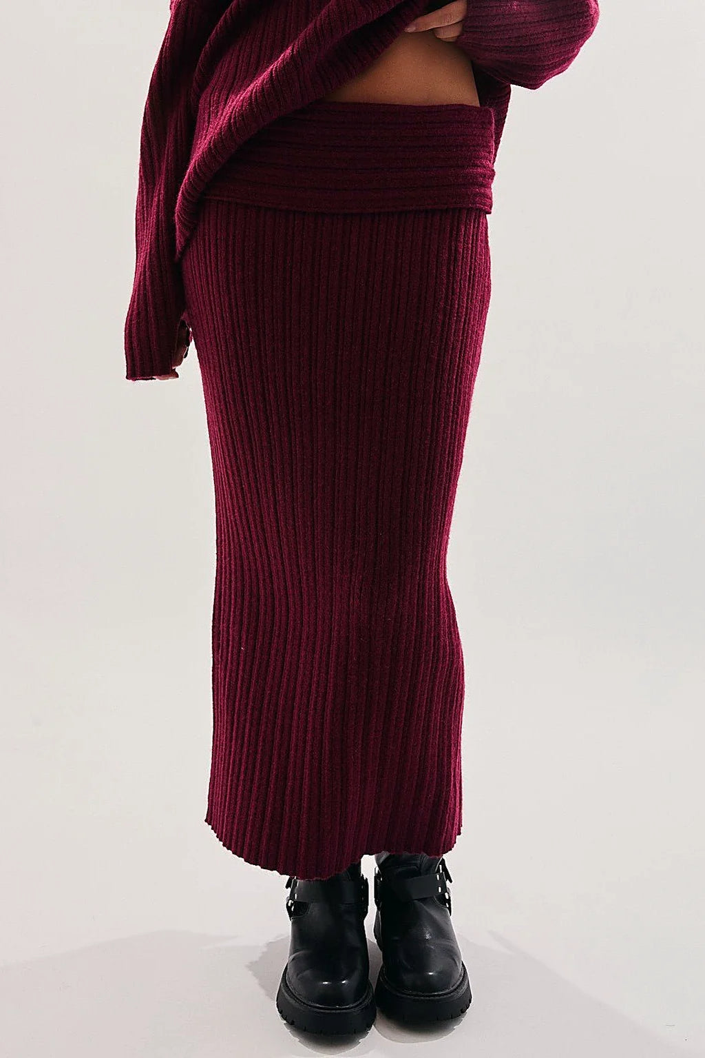 The low waistband of the burgundy knit skirt