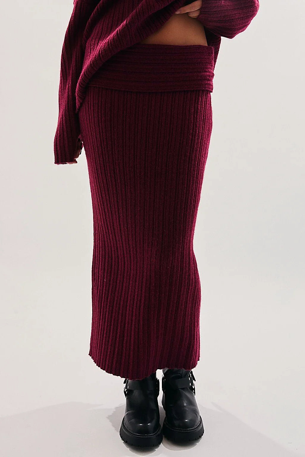 The low waistband of the burgundy knit skirt