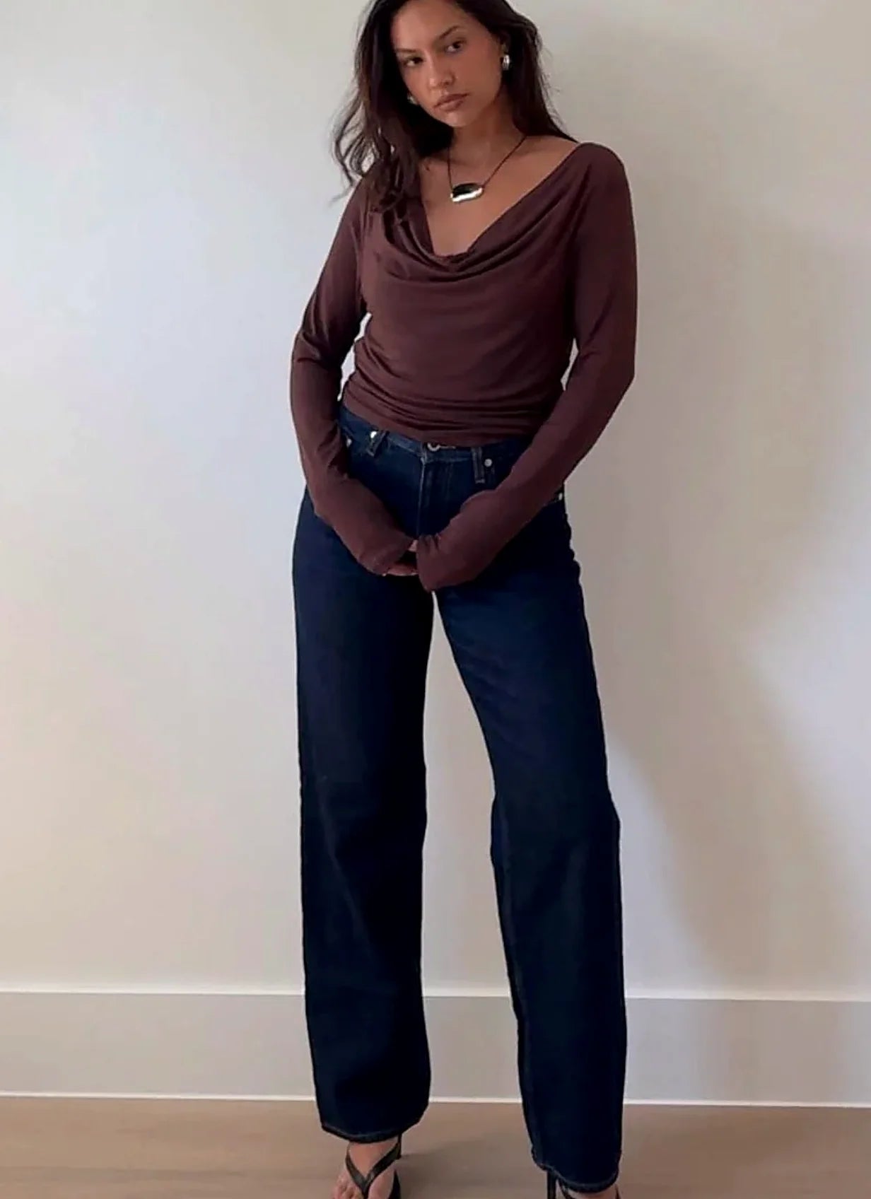 Long sleeve top with fabric draping in folds at the cowl neck