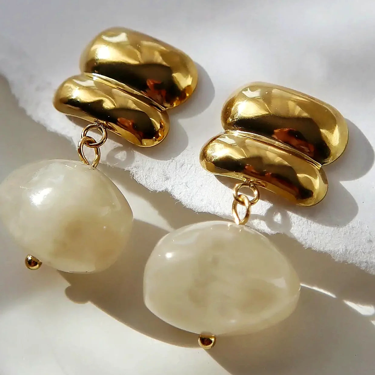 Drop earrings with a gold-plated stud and a white stone bead