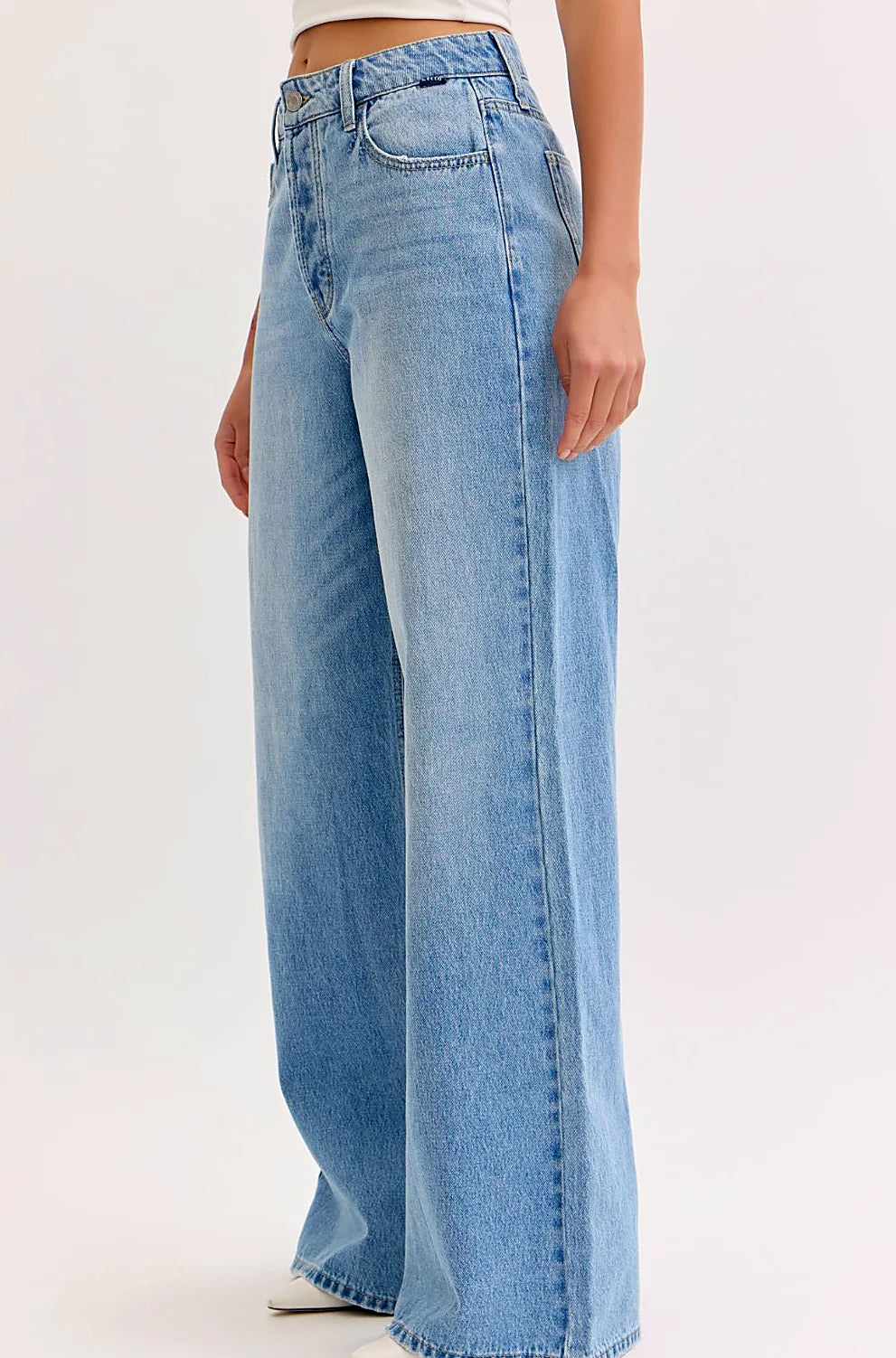 Close view of the zip fly and belt loops at the waist