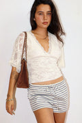 Sheer lace top with a deep scalloped V neckline