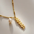 Satellite chain necklace carrying a mama charm and a pearl